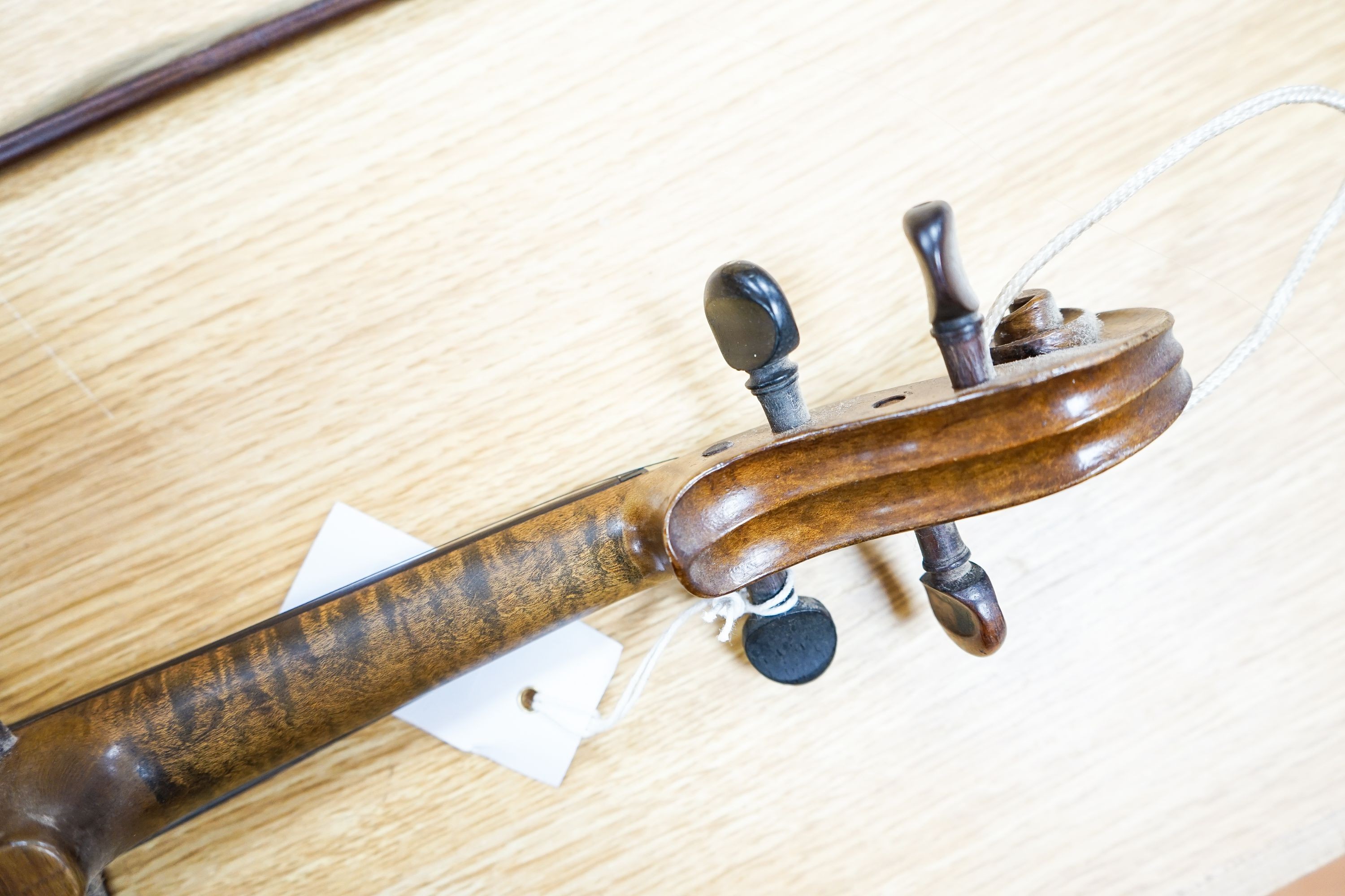 A violin labelled Francesco Ruggeri and a bow. Back of violin excluding button - 36cm